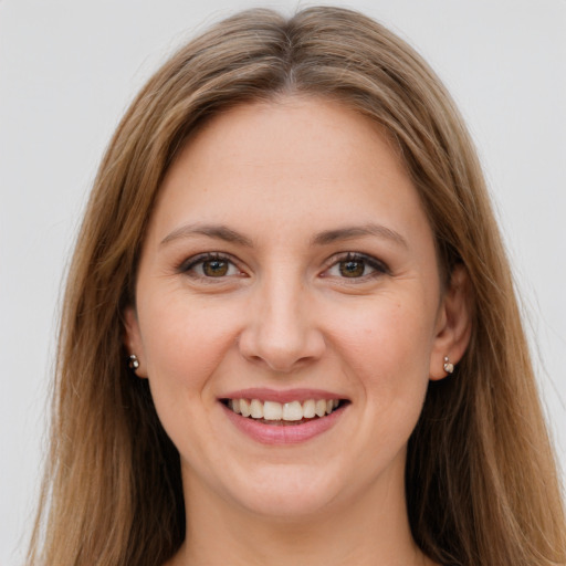 Joyful white young-adult female with long  brown hair and grey eyes