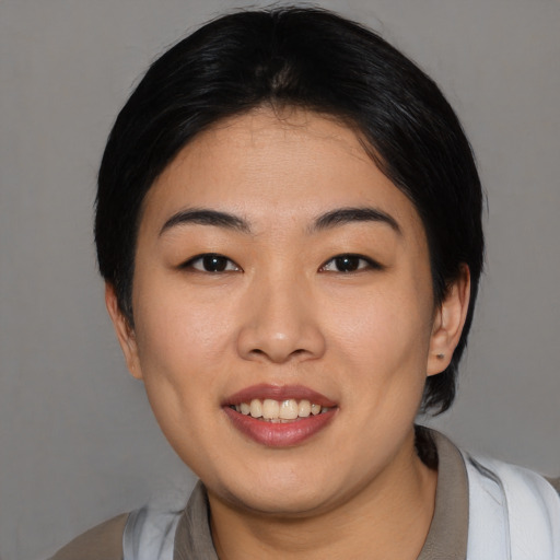 Joyful asian young-adult female with medium  black hair and brown eyes