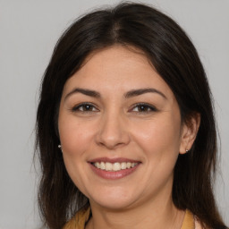 Joyful white young-adult female with medium  brown hair and brown eyes