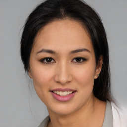 Joyful latino young-adult female with medium  brown hair and brown eyes