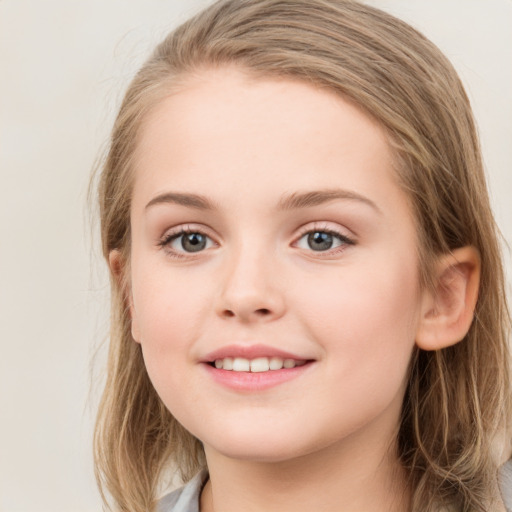 Joyful white child female with long  brown hair and blue eyes