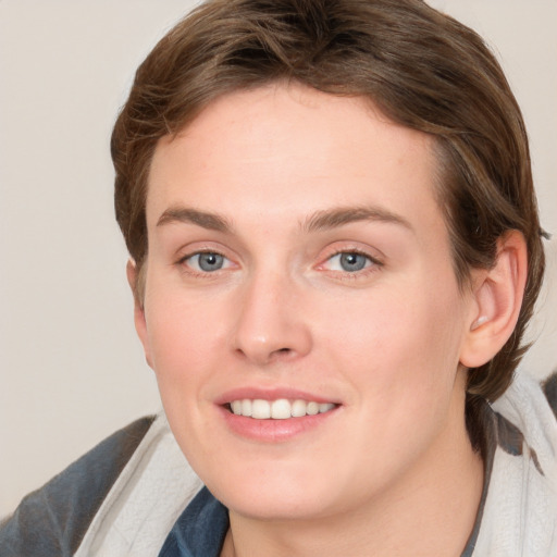 Joyful white young-adult female with medium  brown hair and blue eyes