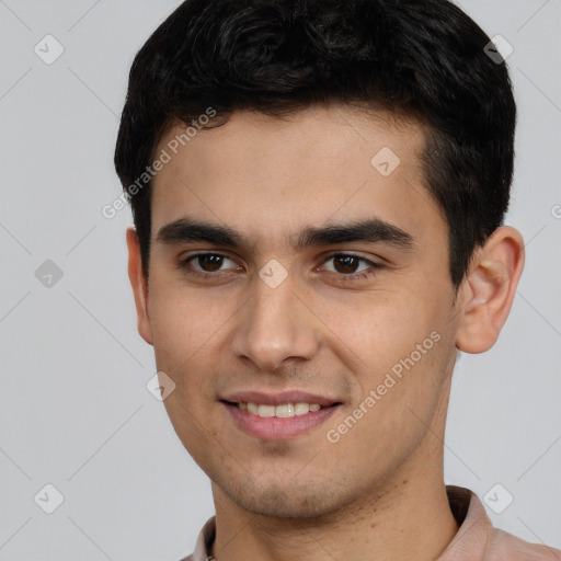 Joyful white young-adult male with short  black hair and brown eyes