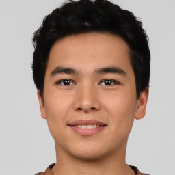 Joyful asian young-adult male with short  black hair and brown eyes