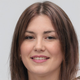 Joyful white young-adult female with long  brown hair and grey eyes