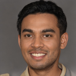 Joyful latino young-adult male with short  black hair and brown eyes