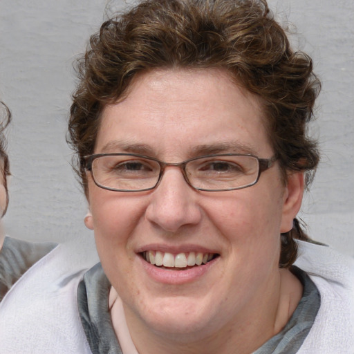 Joyful white adult female with medium  brown hair and blue eyes