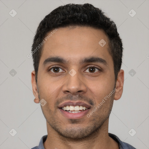 Joyful latino young-adult male with short  black hair and brown eyes