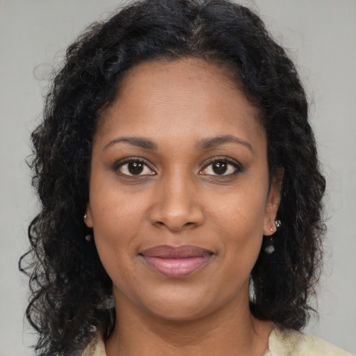 Joyful black adult female with medium  brown hair and brown eyes