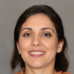 Joyful white adult female with medium  brown hair and brown eyes