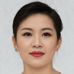 Joyful asian young-adult female with short  brown hair and brown eyes