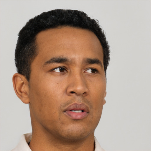 Neutral latino young-adult male with short  black hair and brown eyes
