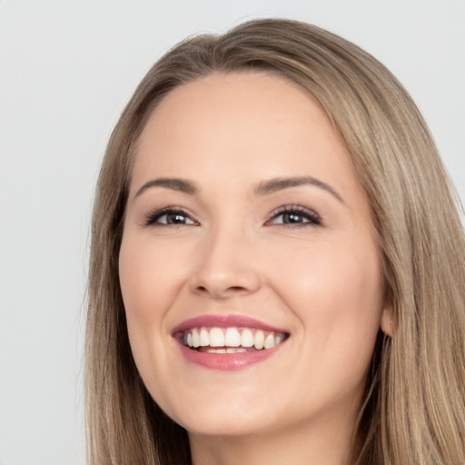 Joyful white young-adult female with long  brown hair and brown eyes