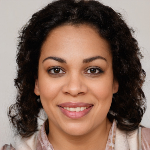 Joyful black young-adult female with medium  brown hair and brown eyes