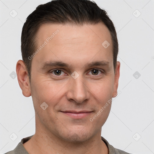 Joyful white young-adult male with short  brown hair and grey eyes