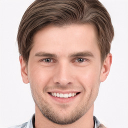 Joyful white young-adult male with short  brown hair and grey eyes