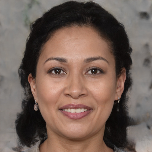 Joyful black adult female with medium  brown hair and brown eyes