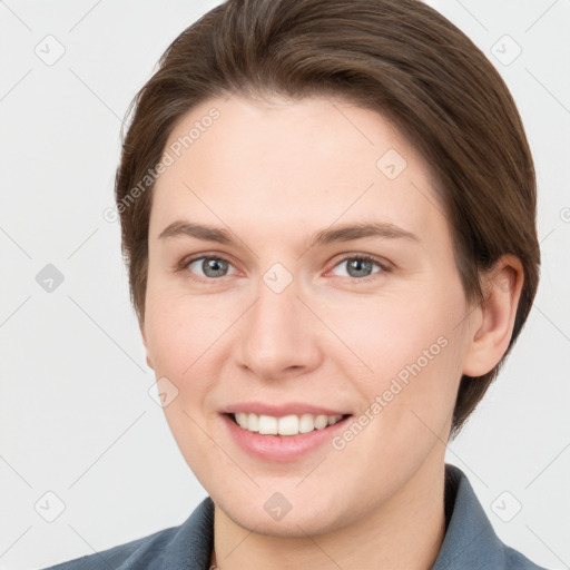 Joyful white young-adult female with short  brown hair and grey eyes