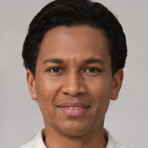 Joyful latino young-adult male with short  brown hair and brown eyes