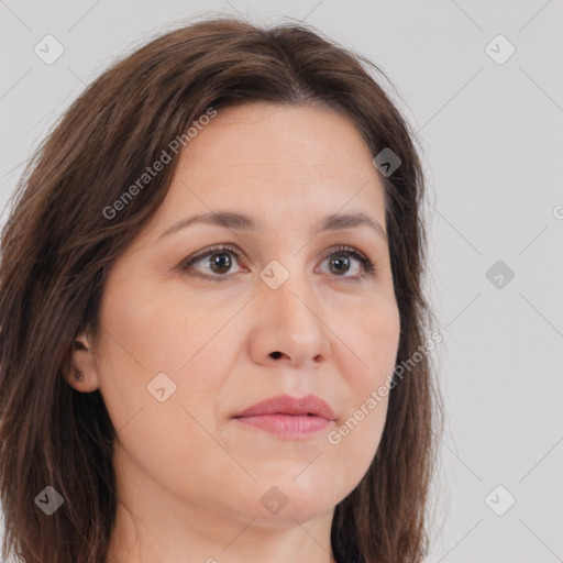 Joyful white adult female with long  brown hair and brown eyes