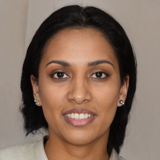 Joyful black young-adult female with medium  black hair and brown eyes