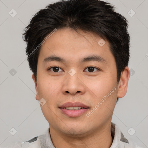 Joyful asian young-adult male with short  brown hair and brown eyes