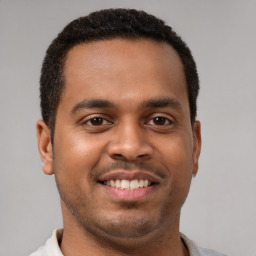 Joyful latino young-adult male with short  brown hair and brown eyes