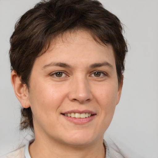 Joyful white adult female with short  brown hair and brown eyes