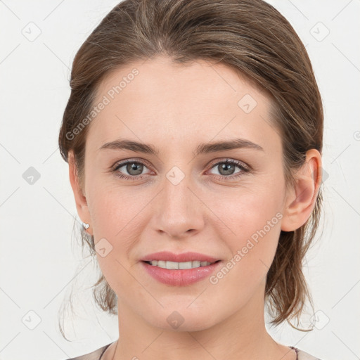 Joyful white young-adult female with medium  brown hair and grey eyes