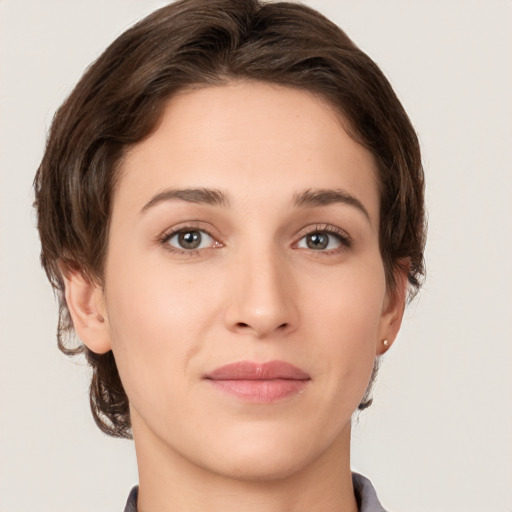 Joyful white young-adult female with medium  brown hair and green eyes