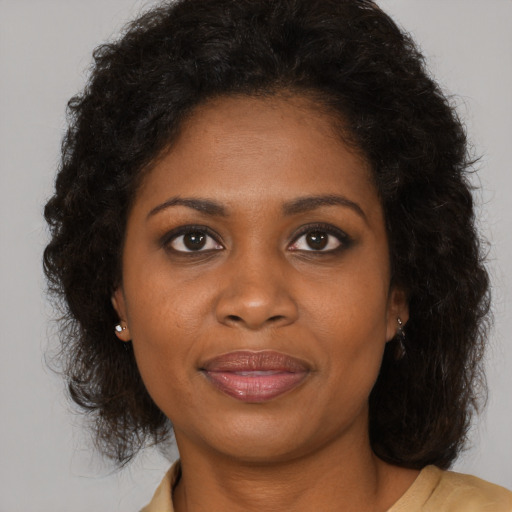 Joyful black young-adult female with medium  brown hair and brown eyes