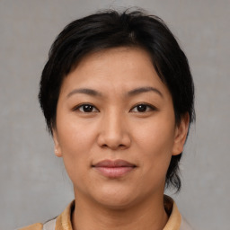 Joyful asian young-adult female with medium  brown hair and brown eyes