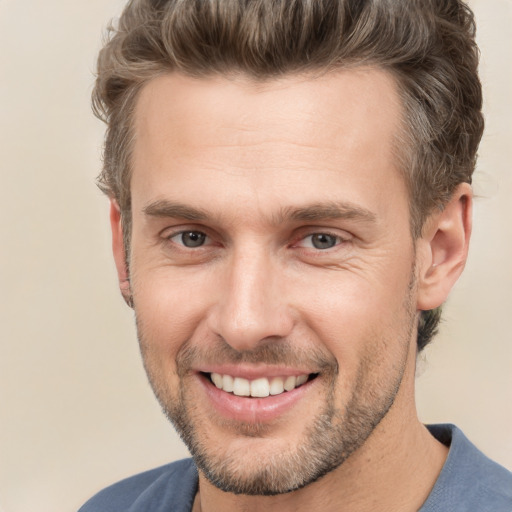 Joyful white adult male with short  brown hair and brown eyes