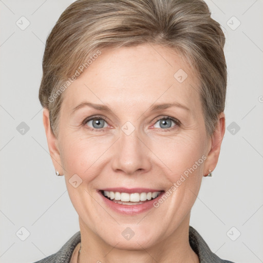 Joyful white adult female with short  brown hair and grey eyes