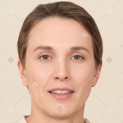 Joyful white young-adult female with short  brown hair and grey eyes