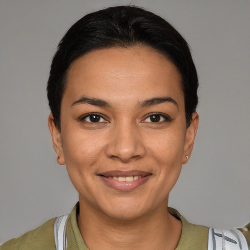 Joyful latino young-adult female with short  black hair and brown eyes