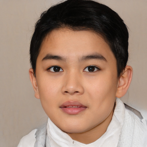 Joyful asian child male with short  brown hair and brown eyes