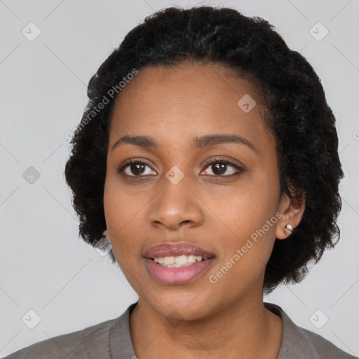 Joyful black young-adult female with short  black hair and brown eyes