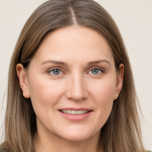 Joyful white young-adult female with long  brown hair and grey eyes