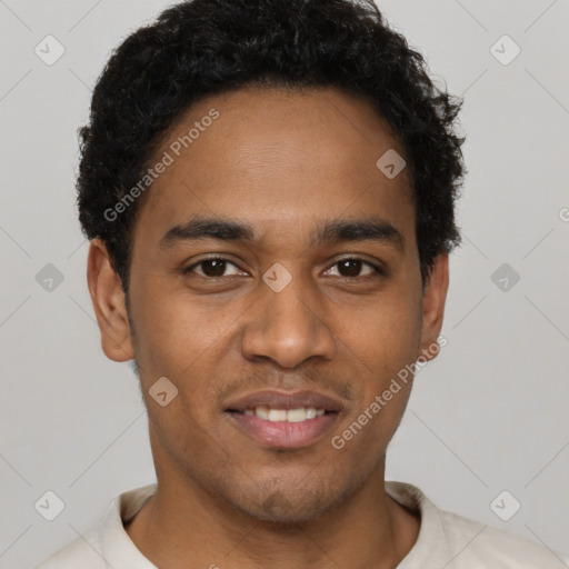Joyful black young-adult male with short  black hair and brown eyes