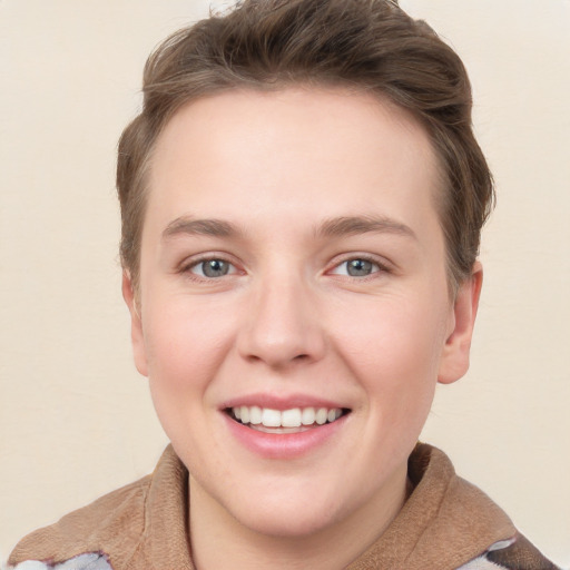 Joyful white young-adult female with short  brown hair and grey eyes