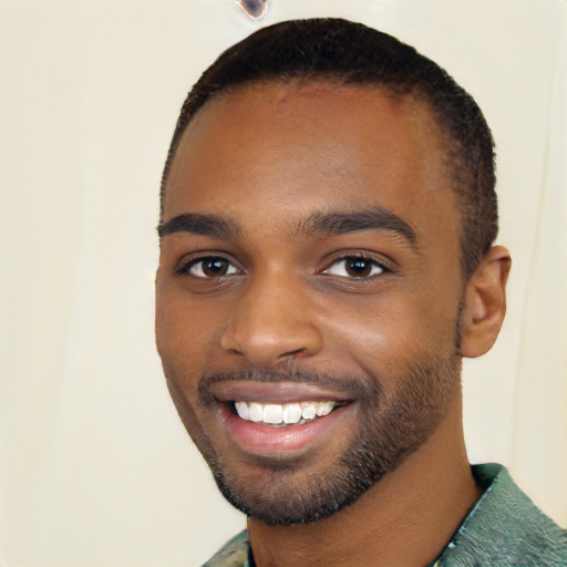 Joyful black young-adult male with short  black hair and brown eyes