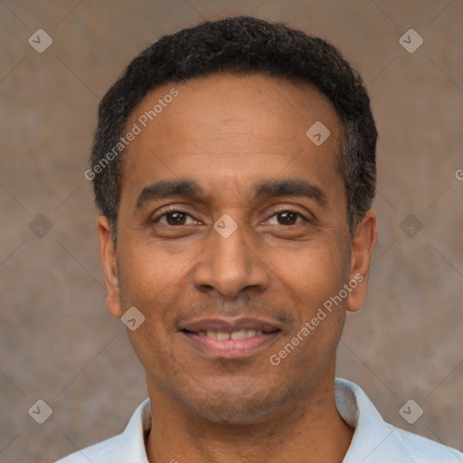 Joyful latino adult male with short  black hair and brown eyes