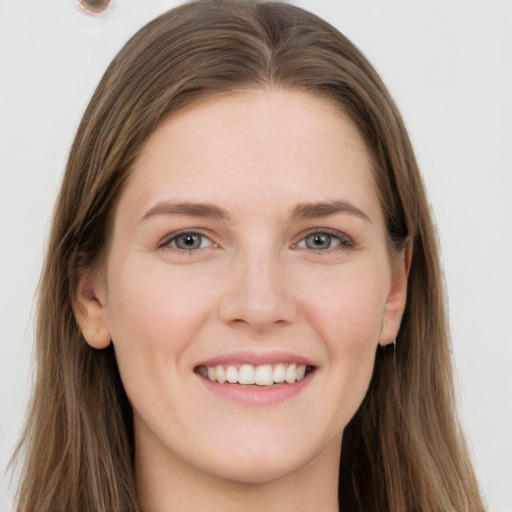 Joyful white young-adult female with long  brown hair and grey eyes