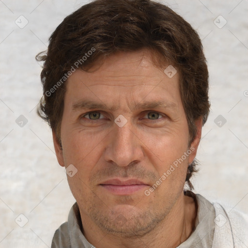 Joyful white adult male with short  brown hair and grey eyes