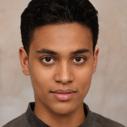 Joyful latino young-adult male with short  brown hair and brown eyes