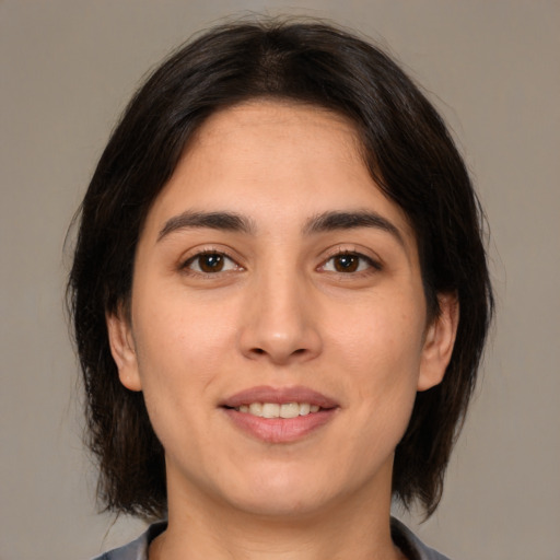 Joyful white young-adult female with medium  brown hair and brown eyes