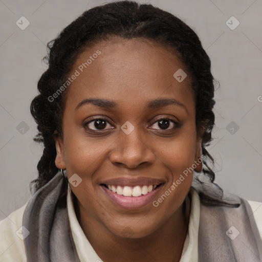 Joyful black young-adult female with long  brown hair and brown eyes