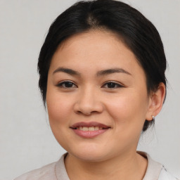 Joyful latino young-adult female with medium  brown hair and brown eyes