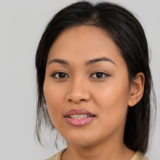Joyful asian young-adult female with long  brown hair and brown eyes